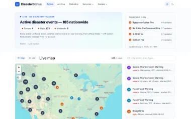 The DisasterStatus live tracker, showing active US disaster events on a map beside a list of current warnings.